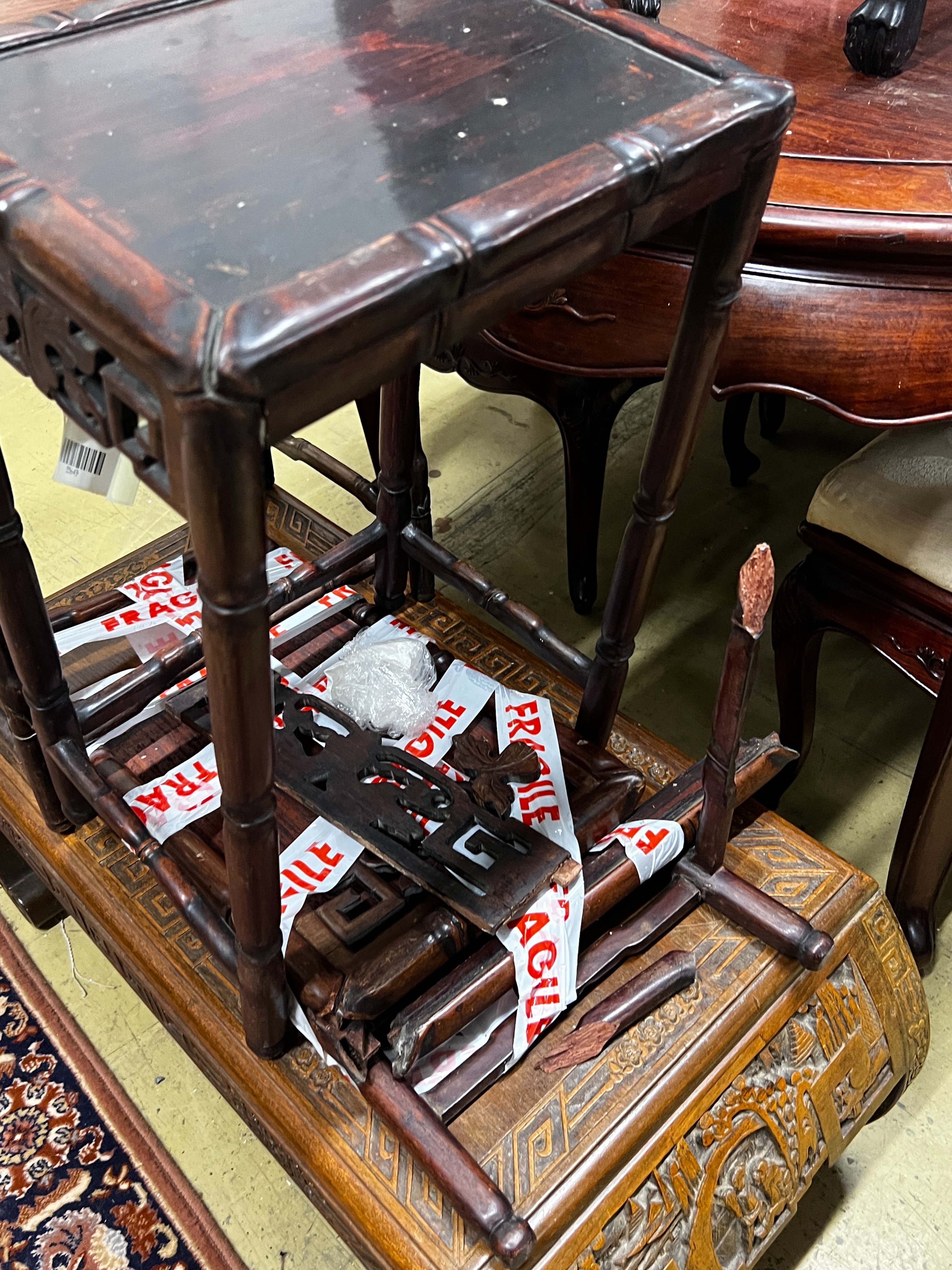 A Chinese carved hardwood low table, length 89cm, depth 43cm, height 36cm together with three Chinese carved hongmu occasional tables (one in need of extensive repair)